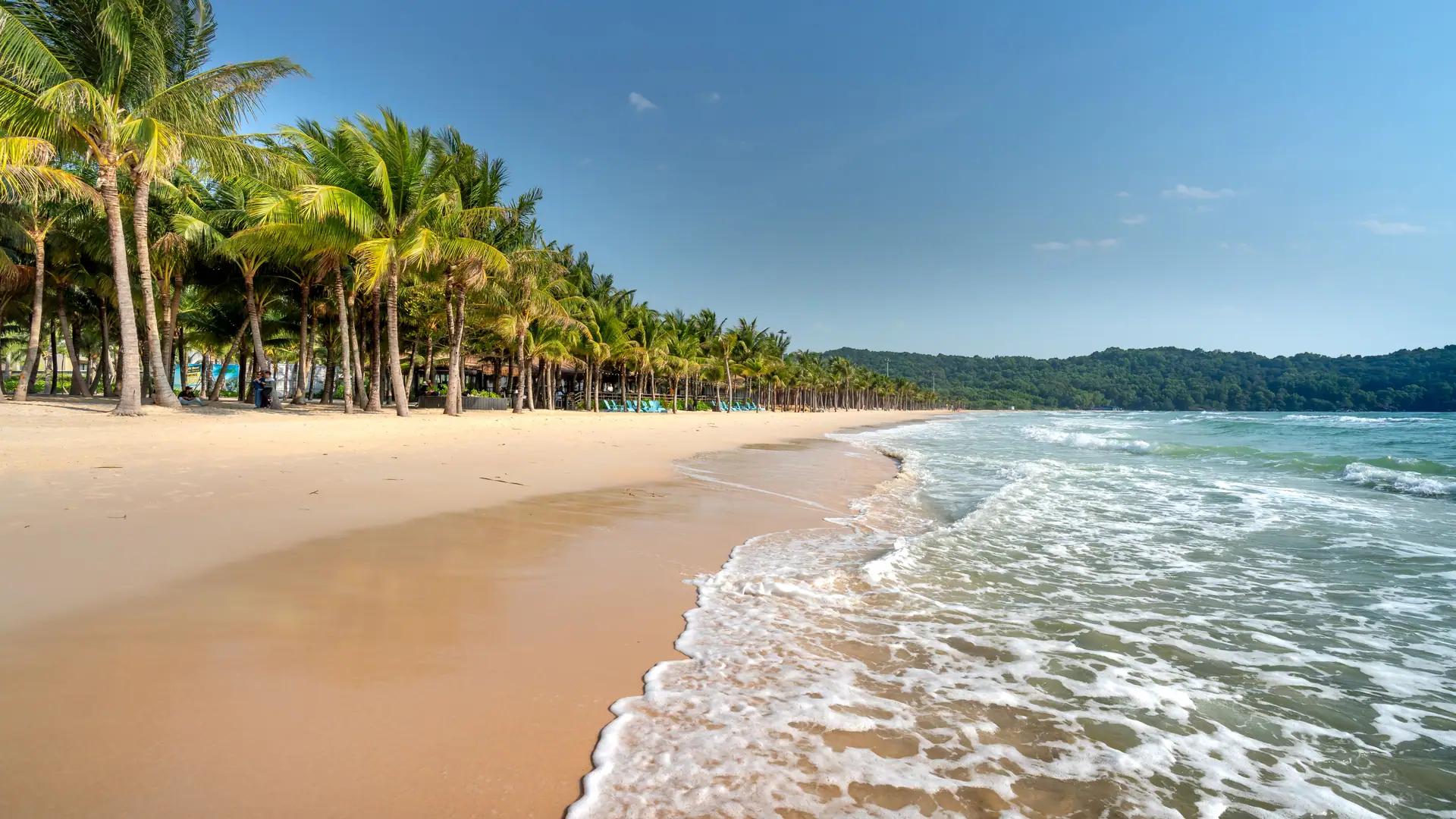 A property consultant greeting a buyer on a sea-view villa terrace in Thailand
